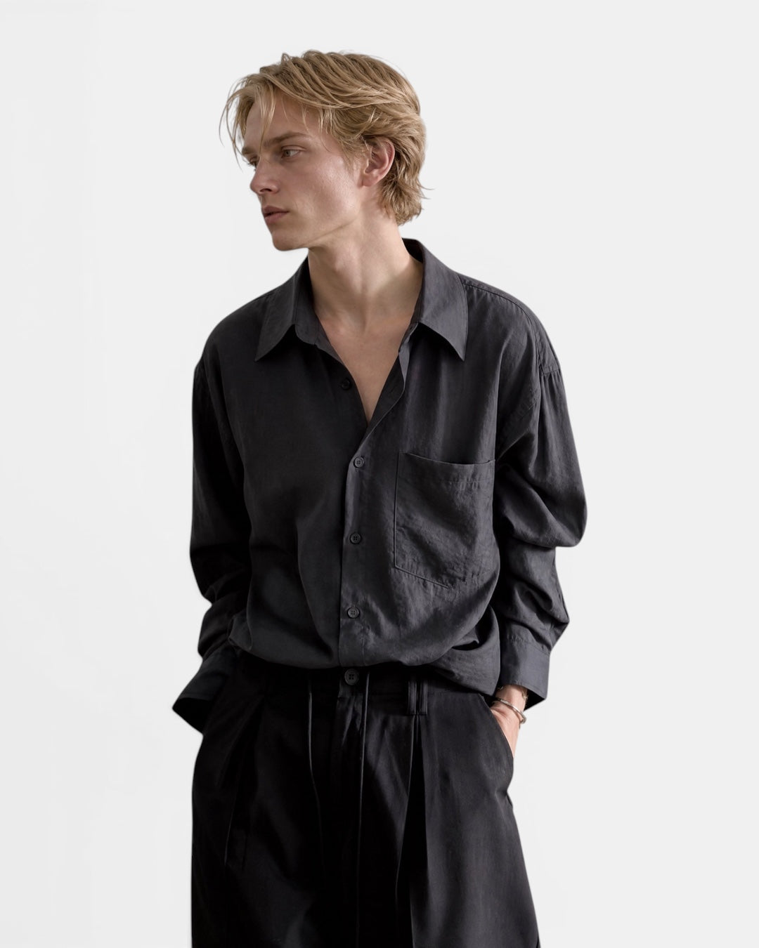 NAMELESS dark grey textured long sleeve linen shirt on a male model. Relaxed fit with a single chest pocket.