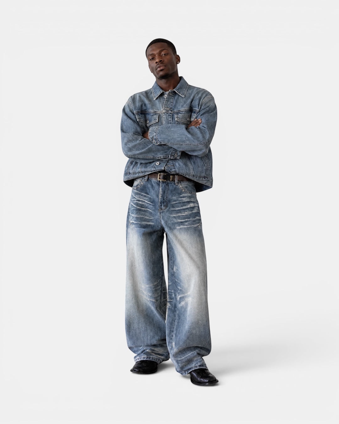 Nameless light wash distressed denim wide-leg jeans with whiskering and fading on a male model.
