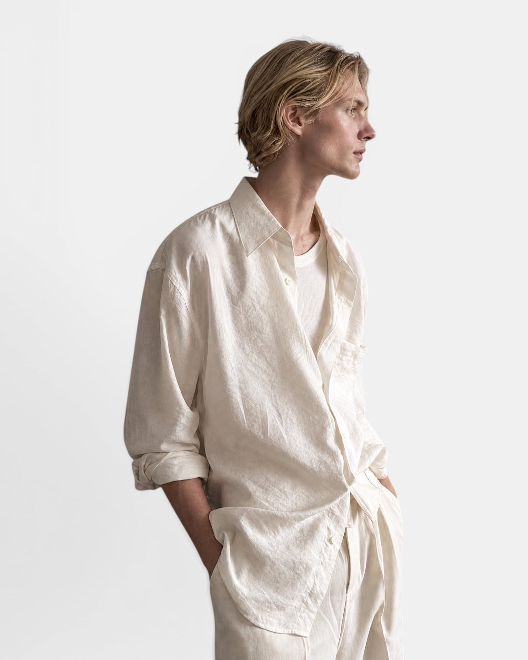 NAMELESS off-white textured linen long sleeve shirt worn by a male model with hands in pockets.